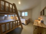 Bunk room with two double beds and a twin